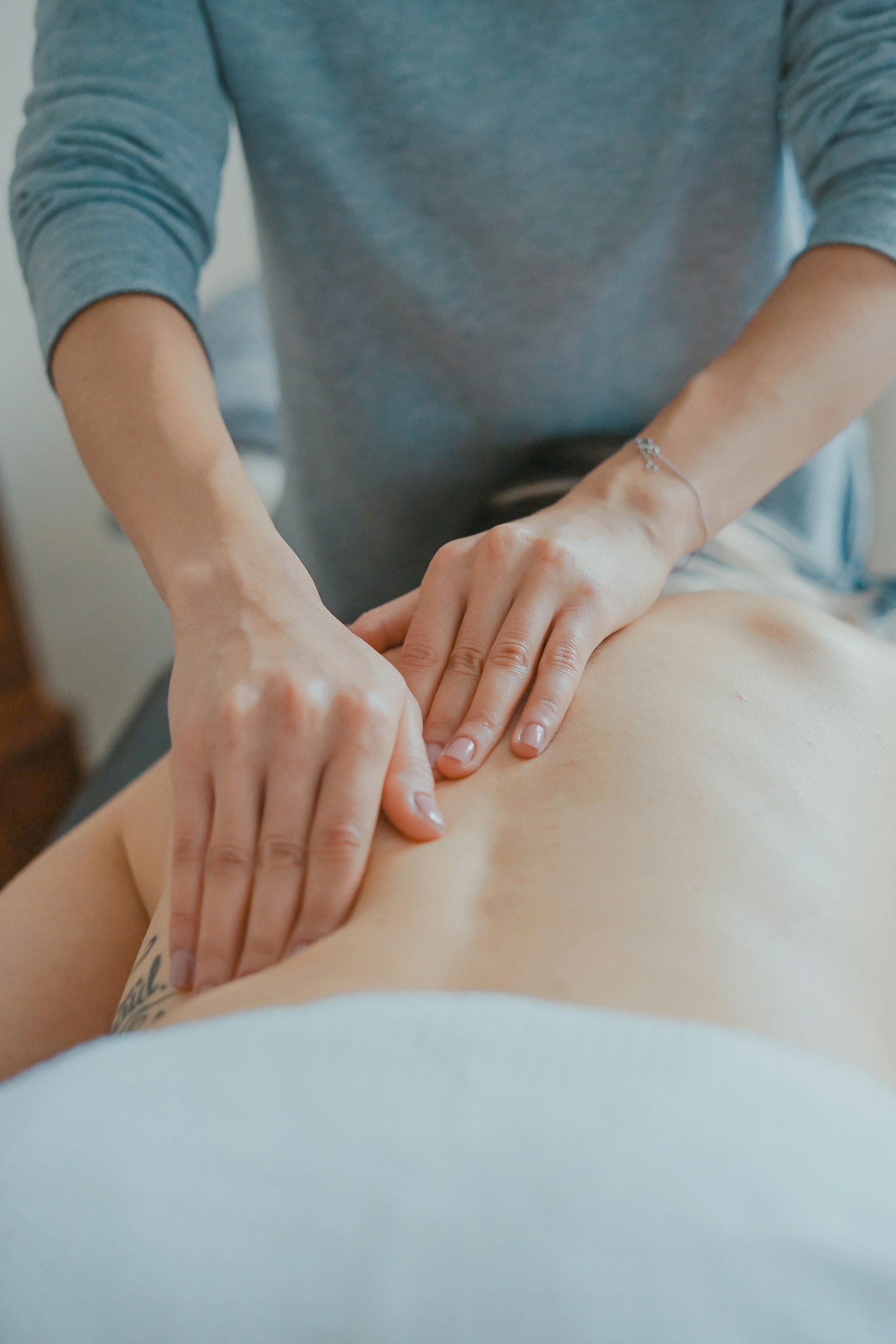 Athlete receiving post-workout massage from a licensed massage therapist.