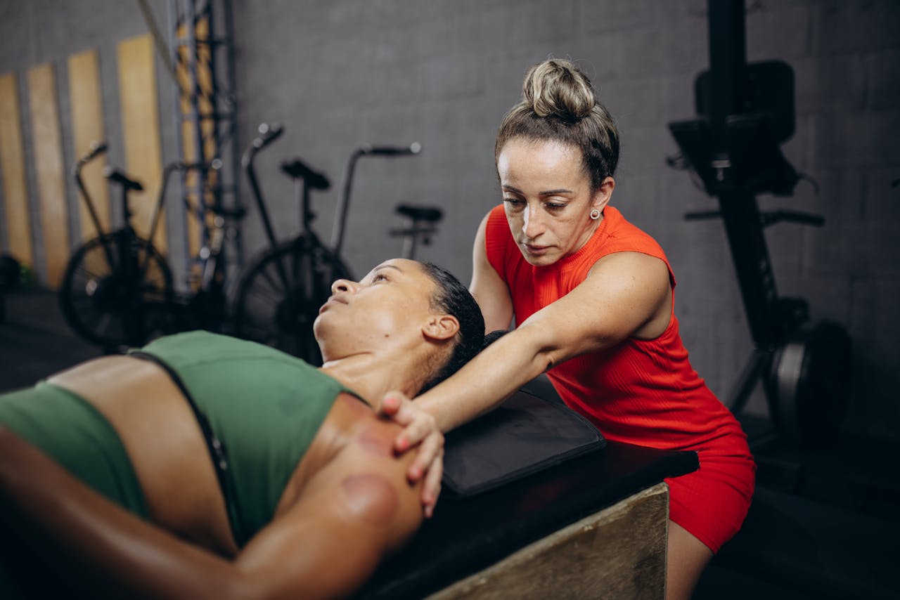 A licensed massage therapist uses slow, calming effleurage strokes during a pre-sports massage.