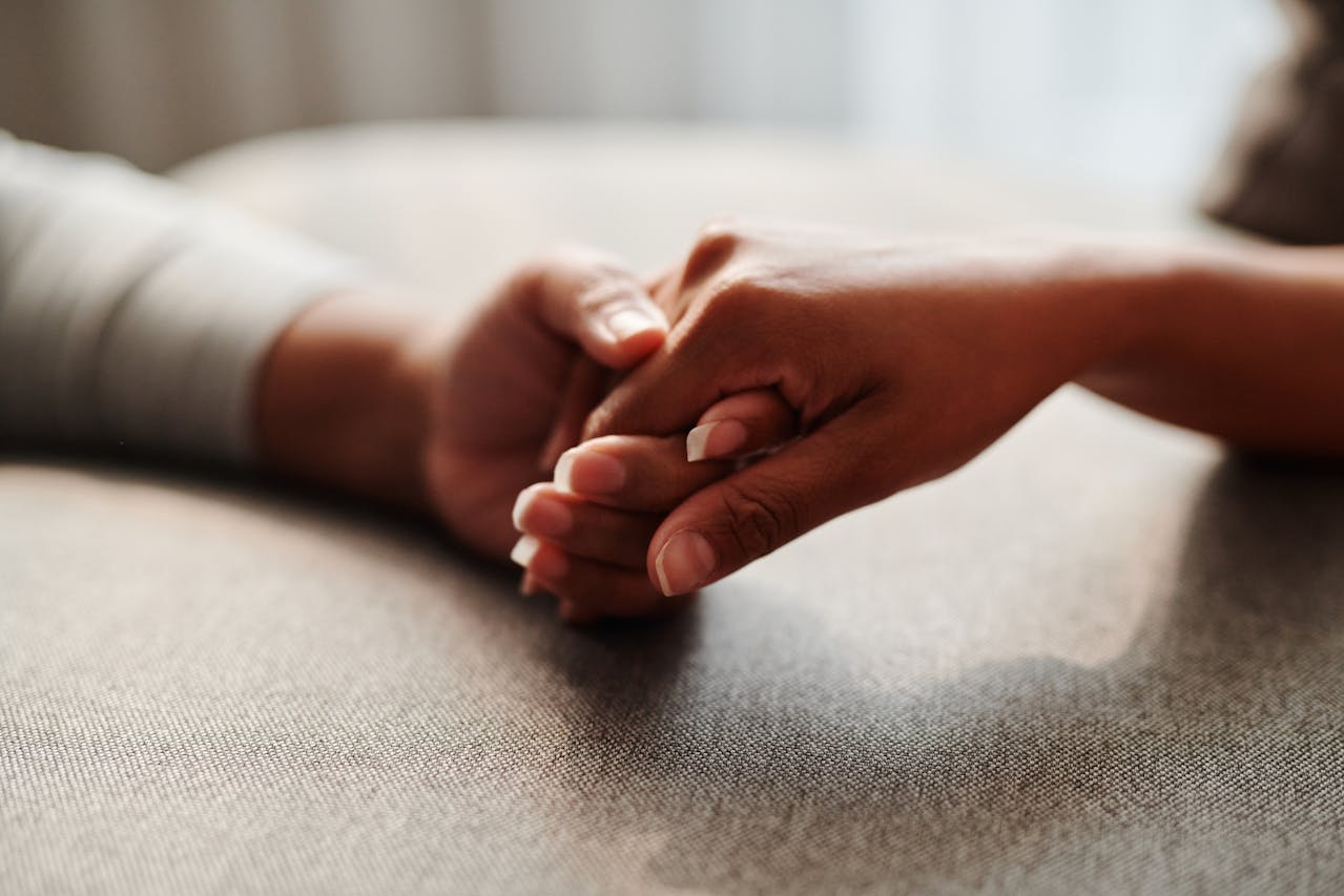 A massage therapist establishes a trusting, caring connection with an older adult client before a geriatric massage session.