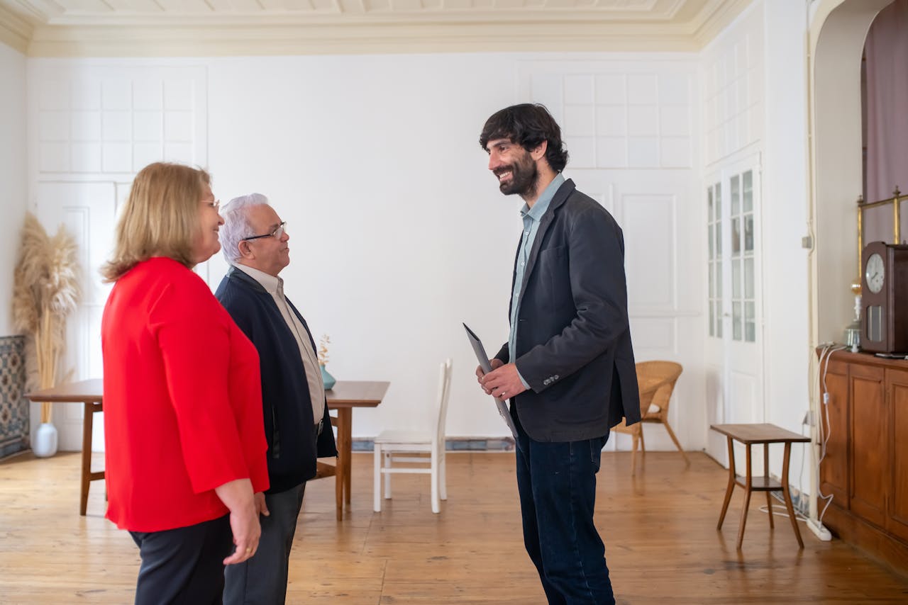 Close-up of a therapist's hands performing the light, rhythmic strokes of lymphatic drainage massage on a client's arm.
