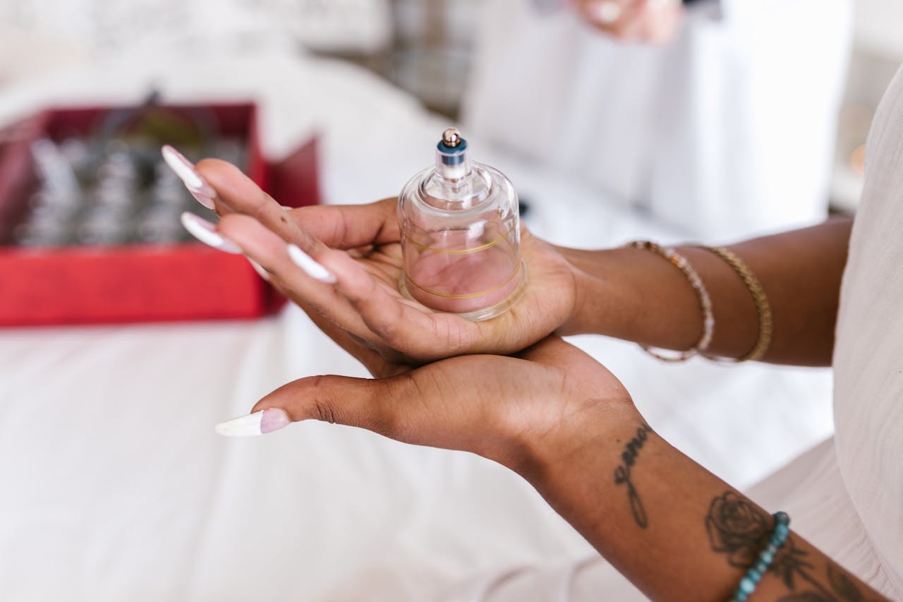 Licensed massage therapist holding a cup used for manual cupping therapy.