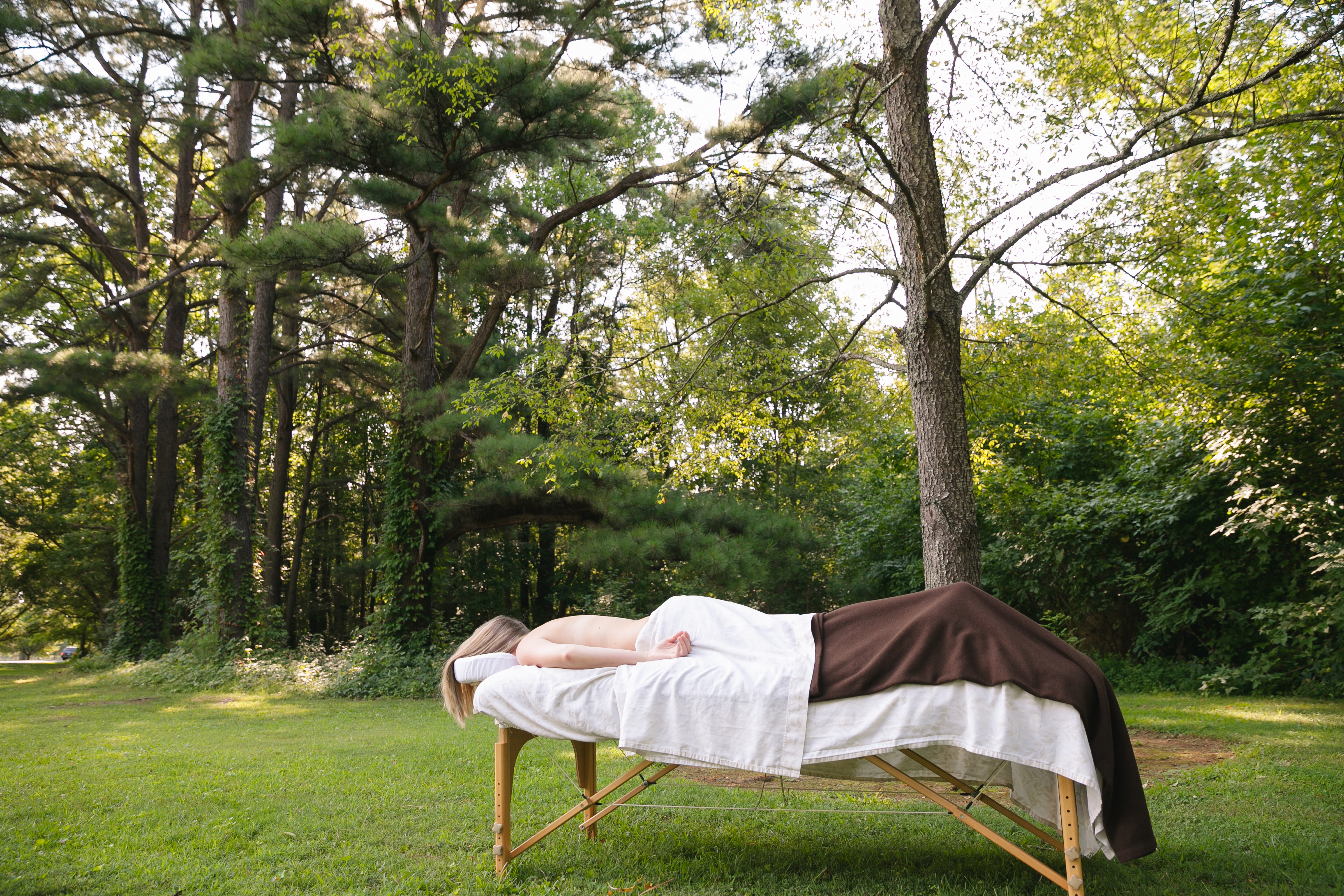 Client fully relaxed while lying on a massage table after receiving a vibration treatment session.